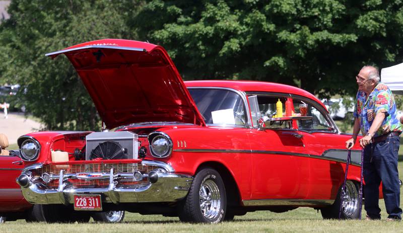Pat Giffin of Marengo admires a 1957 Chevrolet during A Day in the Park hosted by the Marengo Park District Saturday at Indian Oaks Park in Marengo.  Giffin brought his own 1955 Ford to show at the event.