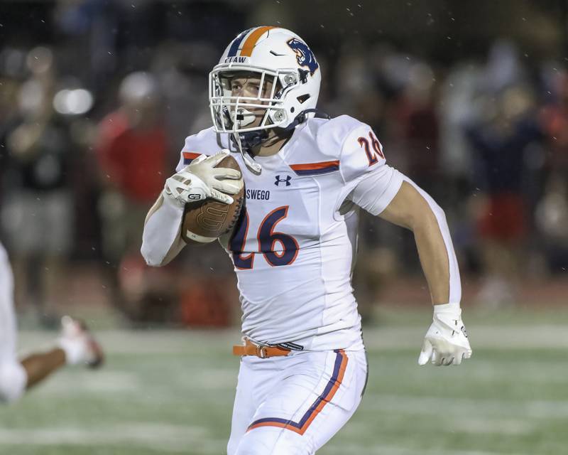 Oswego's Dekker Zelensek (26) takes off down the sidelines on the way to a the endzone for a long touchdown run during football game between Oswego at Naperville Central  on Friday, Aug 29, 2025  in Naperville.