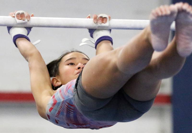 Paige Nagel works on her bars routine during girls gymnastics practice at Crystal Lake Gymnastics Training Center on Monday, Dec. 2, 2019 in Crystal Lake.