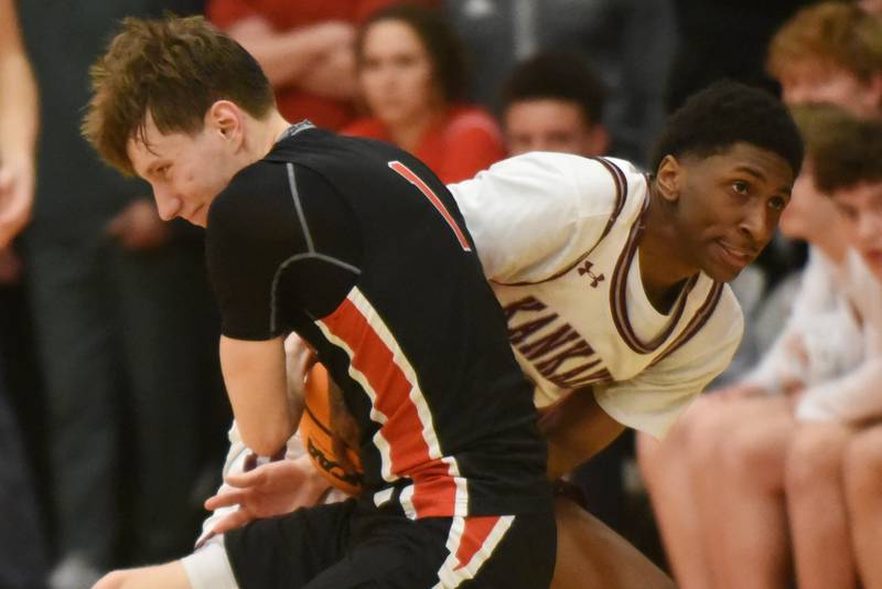 Kankakee's KeShawn Wade, right, tries ripping the ball away from Metamora's Ashton Grieves during the IHSA Class 3A Washington Sectional semifinals Tuesday, March 4, 2025.