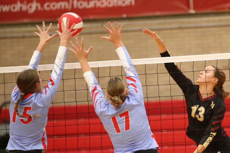 Ottawa's Addison Duggan and teammate Olivia Evola block a spike from Morris's Ava Smith on Tuesday, Sept. 12, 2023 in Kingman Gym at Ottawa High School.