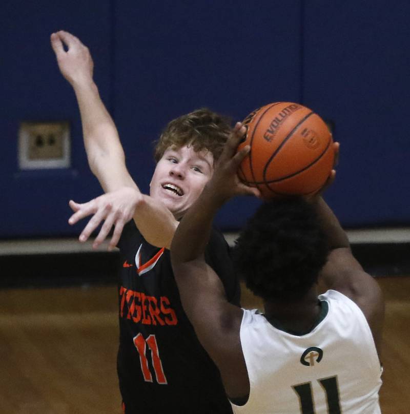 Crystal Lake Central's Preston Mast tries to block the shot of Boylan’s Darrell Johnson during a IHSA Class 3A boys basketball regional boys basketball game Thursday, Feb. 23, 2023, at Woodstock High School.