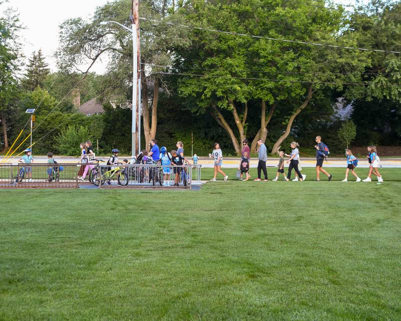 Students place their bikes at the bike rack as others walk for the first day of school at Western Avenue Elementary School on Thursday Aug. 21, 2025, in Geneva.