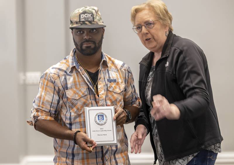 Marcus Sleck receives the John Stern Leadership award from Rhonda Stutzke Thursday, Oct. 17, 2024, at the Self Help client awards banquet.
