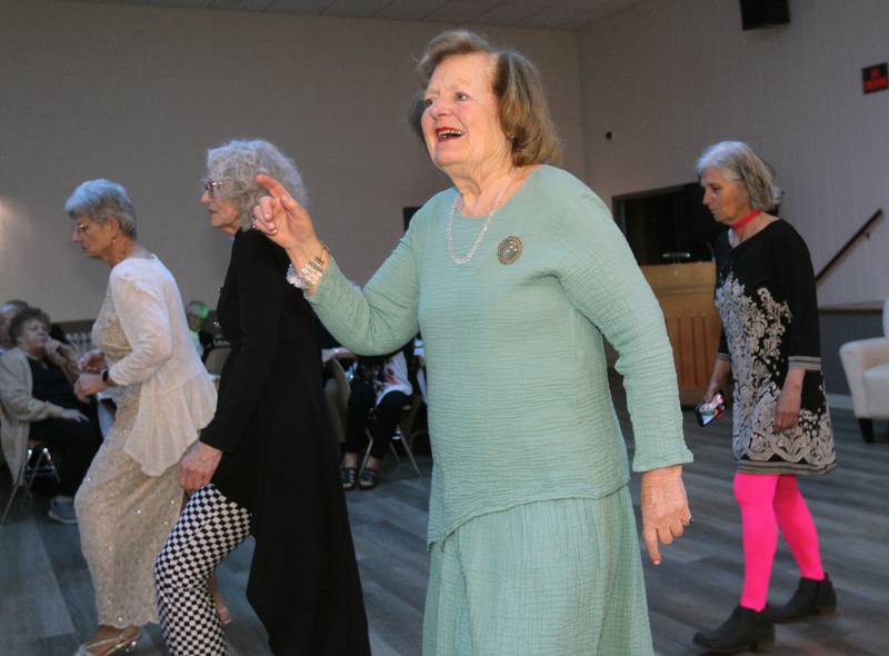 Kathleen Van Ella (second from right) enjoys line dancing during the Senior Prom to celebrate the 50th Anniversary of Leisure Village in Fox Lake