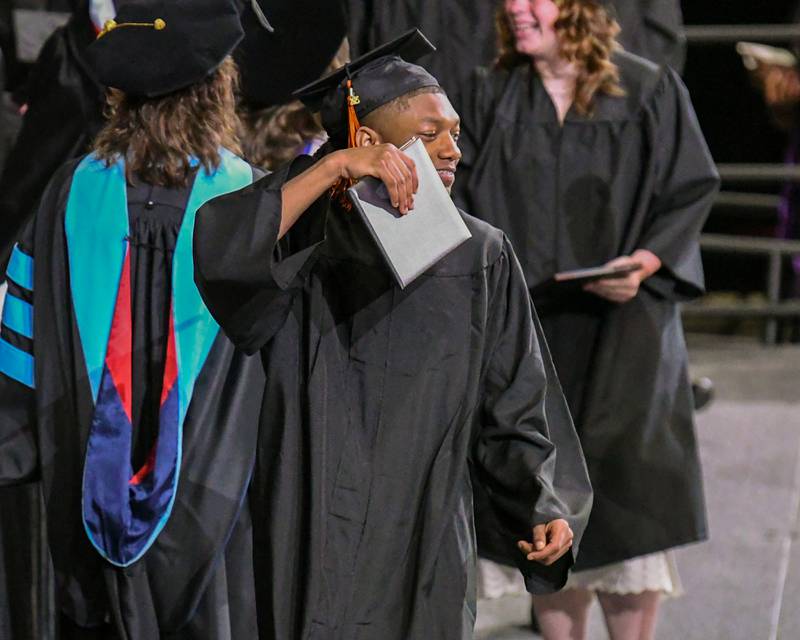 A DeKalb High School senior is all smiles as he shows off his diploma on Saturday, May 24, 2025, during the Class of 2025 Commencement ceremony held at the NIU Convocation Center in DeKalb.