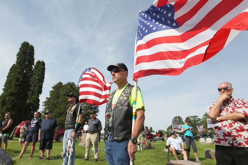 Jeff Greene, of Antioch, U.S. Navy veteran, holds the American flag Monday, May 30, 2022, during the Antioch Memorial Day Ceremony at Hillside Cemetery in Antioch. Cpl. Allen D. Hanke (killed in action) and his brother PFC Leslie A. Hanke (wounded in action) both served during WWII and were honored during the ceremony. The Hanke brothers are buried at the cemetery.
