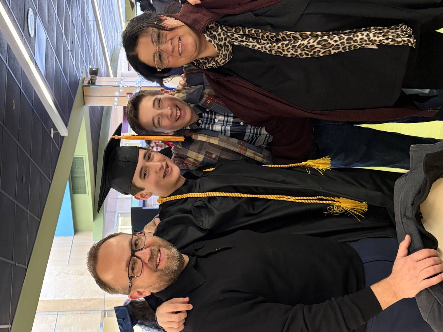 Lucas Hernacki (second from the left), 16, of Cary, with his family after graduating with honors from McHenry County College on Dec. 13, 2025.