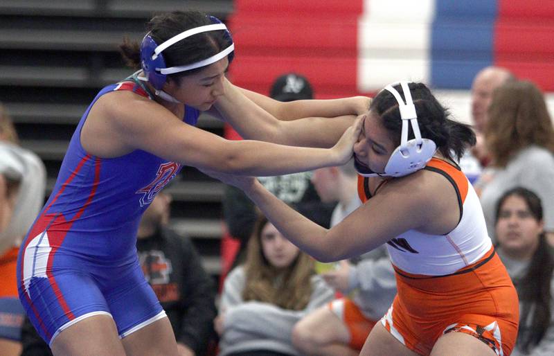 McHenry’s Natalie Corona, right, battles Dundee-Crown’s Daniella Ibanez in a 145-pound bout in varsity girls wrestling at Carpentersville Thursday night.