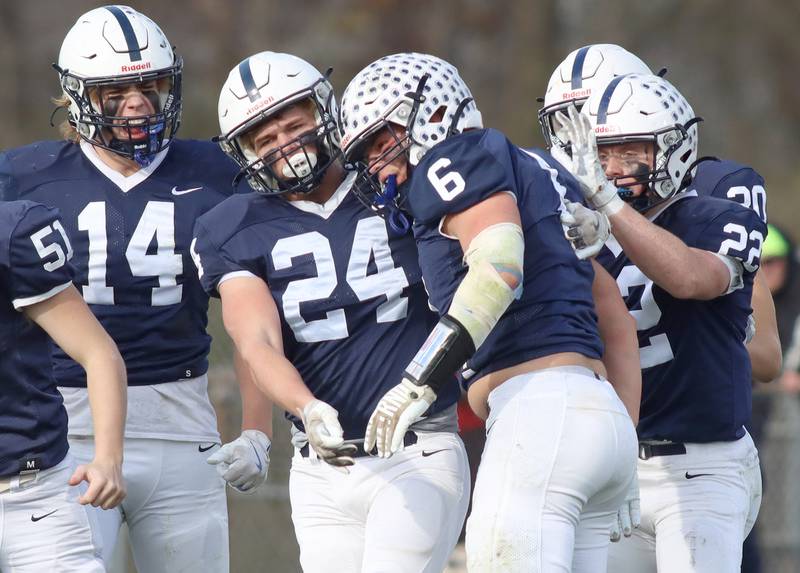 Cary-Grove’s Charlie Ciske, center, celebrates with Ostin. Hansen, Brian Barwig and Michael Dunkin after a defensive stop against Belvidere North in IHSA Class 6A quarterfinal playoff football action on Saturday, Nov. 16, 2024, at Al Bohrer Field on the campus of Cary-Grove High School in Cary.