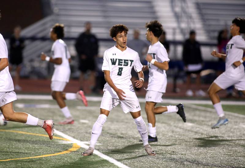 Glenbard West’s Alex Ginder (center) celebrates his goal during the Class 3A St. Charles North Sectional semifinal against Geneva on Tuesday, Oct. 29, 2024 in St. Charles.