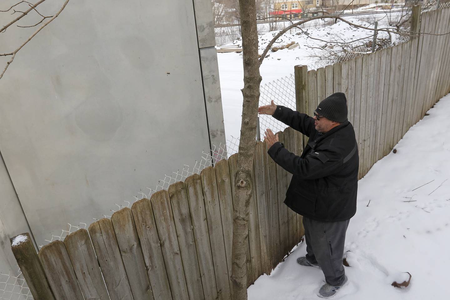 Bettendorf Castle resident William Strohl shows the parking structure seen from his neighbor's backyard on Tuesday, Jan. 4, 2022, as he discusses the new apartment complex being built at the intersection of Algonquin Road and Northwest Highway in Fox River Grove.  The building was supposed to include a two-story underground parking deck and five residential floors above it, according to Strohl.