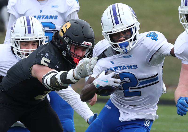 St. Francis' Ian Willis pulls away from Sycamore's Kyle Prebil Saturday, Nov. 16, 2024, during their Class 5A quarterfinal game at Sycamore High School.