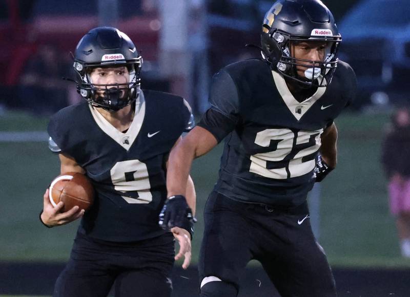 Sycamore's Griffin Larsen follows the blocking of teammate Dylan Curtis during their game against Mahomet-Seymour Friday, Sept. 12, 2025, at Sycamore High School.