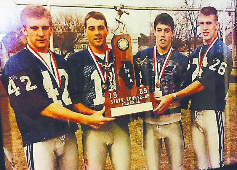 Team captains for the 1989 Princeton Tigers, Kirk Stevens (left), Doug Bruyn, Chad Hamel and Kipp Wahlgren, proudly display the Class 3A State Runner-up trophy they brought home. No PHS team has reached the state finals since.