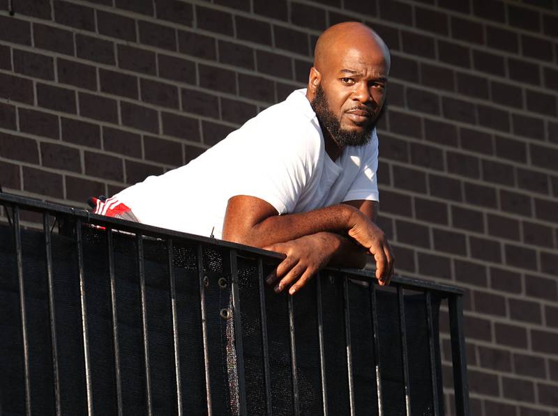 Onlookers came out on their balconies to watch the marchers pass by Friday, July 18, 2025, during the DeKalb Peace Walk and Rally. The event, which featured a march, food vendors and music, was held to encourage the community to work together against gun violence.