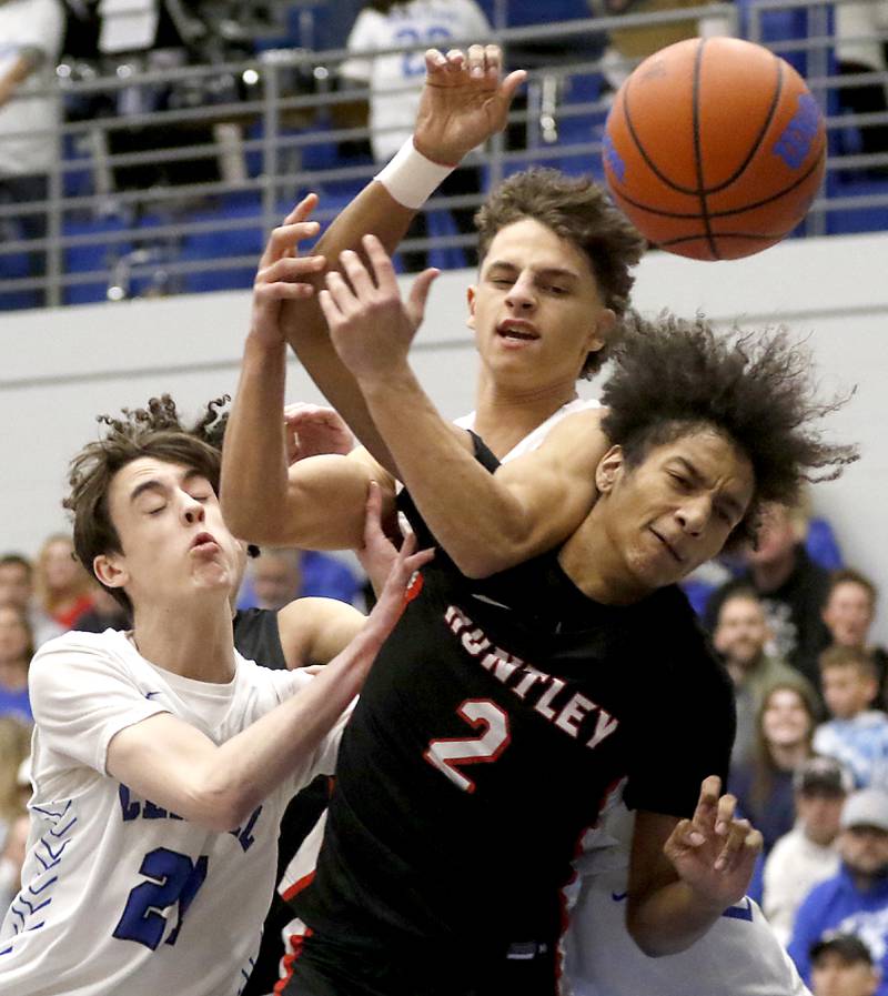 Huntley's Omare Segarra battles with Burlington Central's Patrick Magan (left) and Lucas Kerr for a rebound during a Fox Valley Conference boys basketball game on Friday, Dec. 15, 2023, at Burlington Central High School.