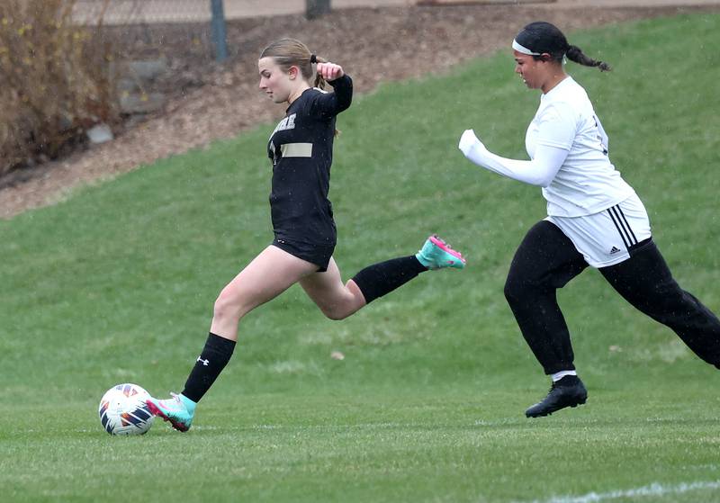 Sycamore's Lizzie Goff takes a shot in front of La Salle-Peru's Aiyanna Smith during their game Wednesday, April 9, 2025, at Sycamore High School.