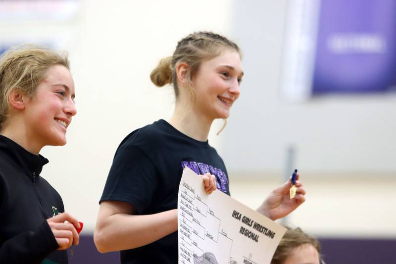 Hampshire’s Stella Piazza accepts a bracket and medal after a win over Crystal Lake South’s Annalee Aarseth, left, at 115 pounds in varsity girls IHSA Regional Championship wrestling action on Saturday, February 7, 2026, at Hampshire High School in Hampshire.