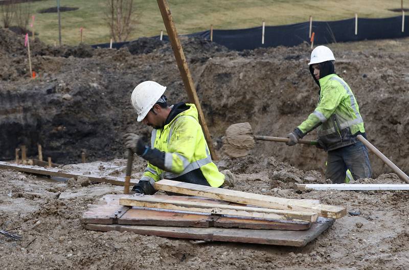 Workers from Upland Concrete, work on a foundation of a new home in the Woodlore Estates subdivision in Crystal Lake on Thursday, Jan. 19, 2023.