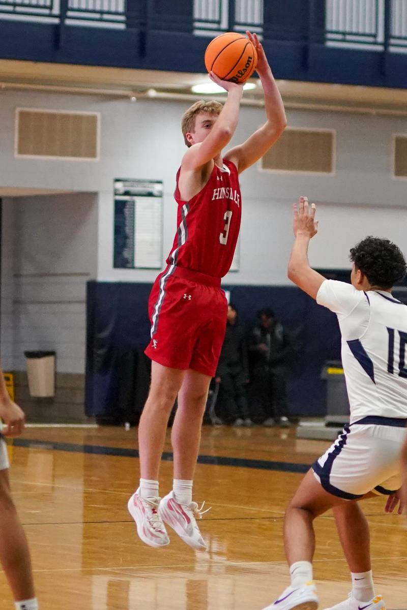 Hinsdale Central's Dillon Dell (3) shoots a three pointer over Oswego East's Damien Lewandowski (10) during a hoops for healing tournament basketball game at Oswego East High School on Tuesday, Nov. 26, 2024.