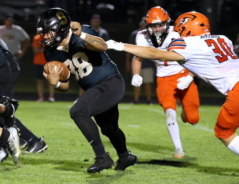 Sycamore's Jayson Panganiban pulls away from Mahomet-Seymour's Luke Buh during their game Friday, Sept. 12, 2025, at Sycamore High School.