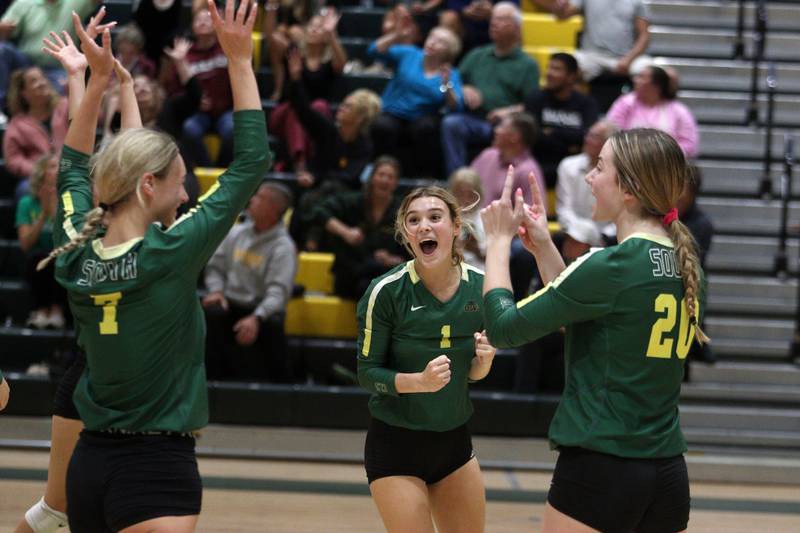 From left, Crystal Lake South’s Gabby Wire, Olivia Apt and Morgan Johnson celebrate a three-set win over Prairie Ridge in varsity volleyball at Crystal Lake South Tuesday night.