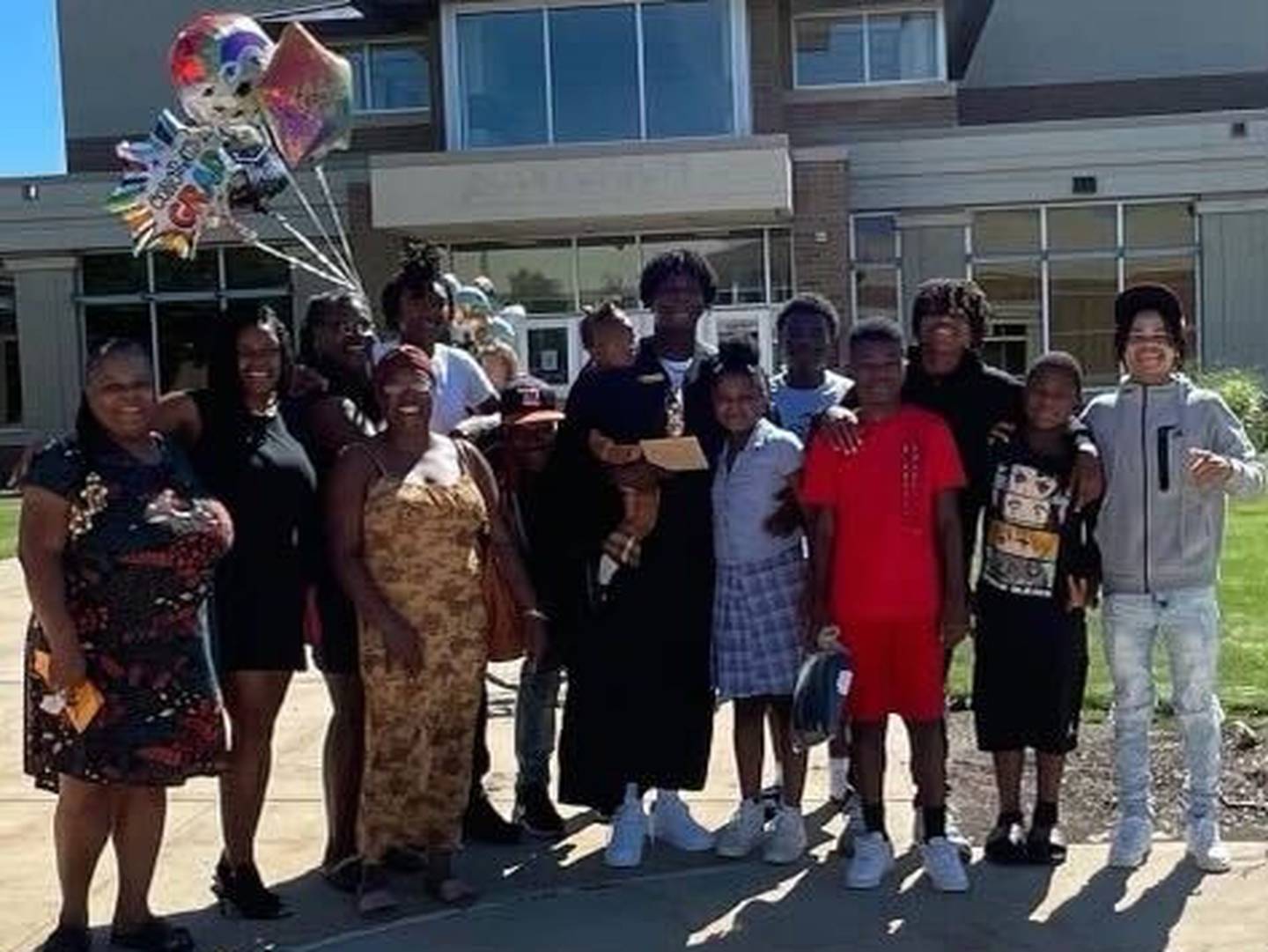 Marlon King Jr. (middle) holds daughter, Ari, and poses with his family during his spring 2022 DeKalb High School graduation. King was fatally shot May 11, 2023 in DeKalb. Two men, Jayden C. Hernandez and Carreon S. Scott, also of DeKalb, are charged with first-degree murder in his death.