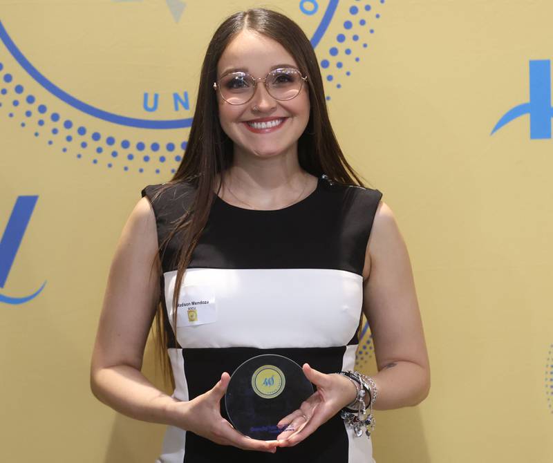 Madison Mendoza poses with her 40 Under Forty award during the Illinois Valley Chamber of Commerce Champions of Change Awards Night on Wednesday, May 6, 2026 at the Westclox Event Center in Peru.
