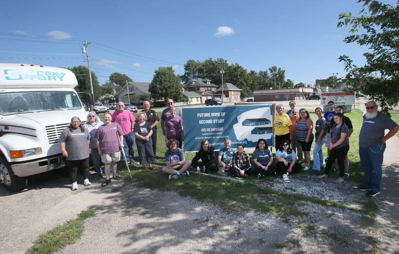 Volunteers and community members mingle near the future home of the Second Story Teen Center will be built at the intersection of Crown Street and South Main Street on Wednesday, Aug. 16, 2023 in Princeton.