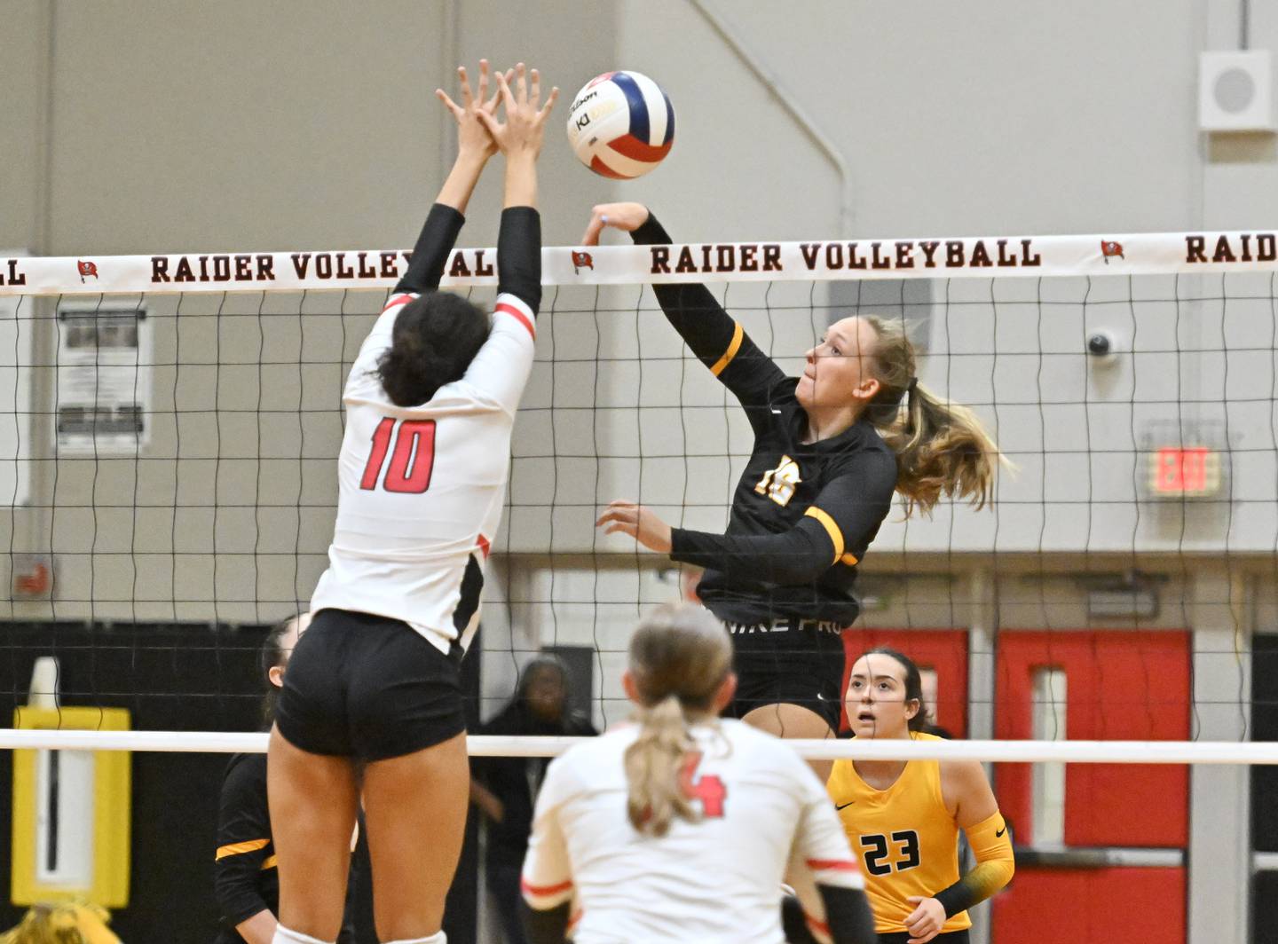 Joliet West's Peyton Darguzis attempts to hit the ball over Bolingbrook's Bianca Fefee  during a non-conference game on Wednesday, Aug. 23, 2023, at Bolingbrook. (Dean Reid for Shaw Local News Network)