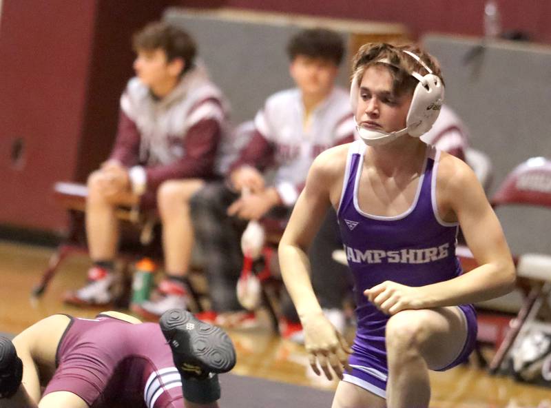Hampshire’s David Wesierski gets to his feet after a win over Prairie Ridge’s Angelo Bueno at 113 pounds in varsity boys wrestling on Thursday, Dec. 4, 2025, at  Prairie Ridge High School in Crystal Lake.