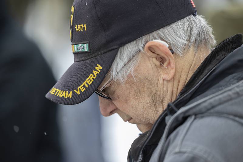 An attendee to the Saturday, Dec. 13, 2025, Wreaths Across America ceremony bows his head in prayer at the start of the recognition.