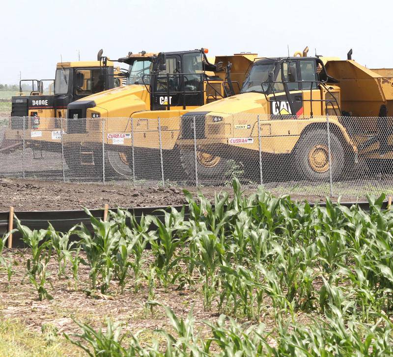 Construction equipment sits next to a cornfield on Crego Road near Gurler Road Monday ready to begin work on a project across from the ChicagoWest Business Center.