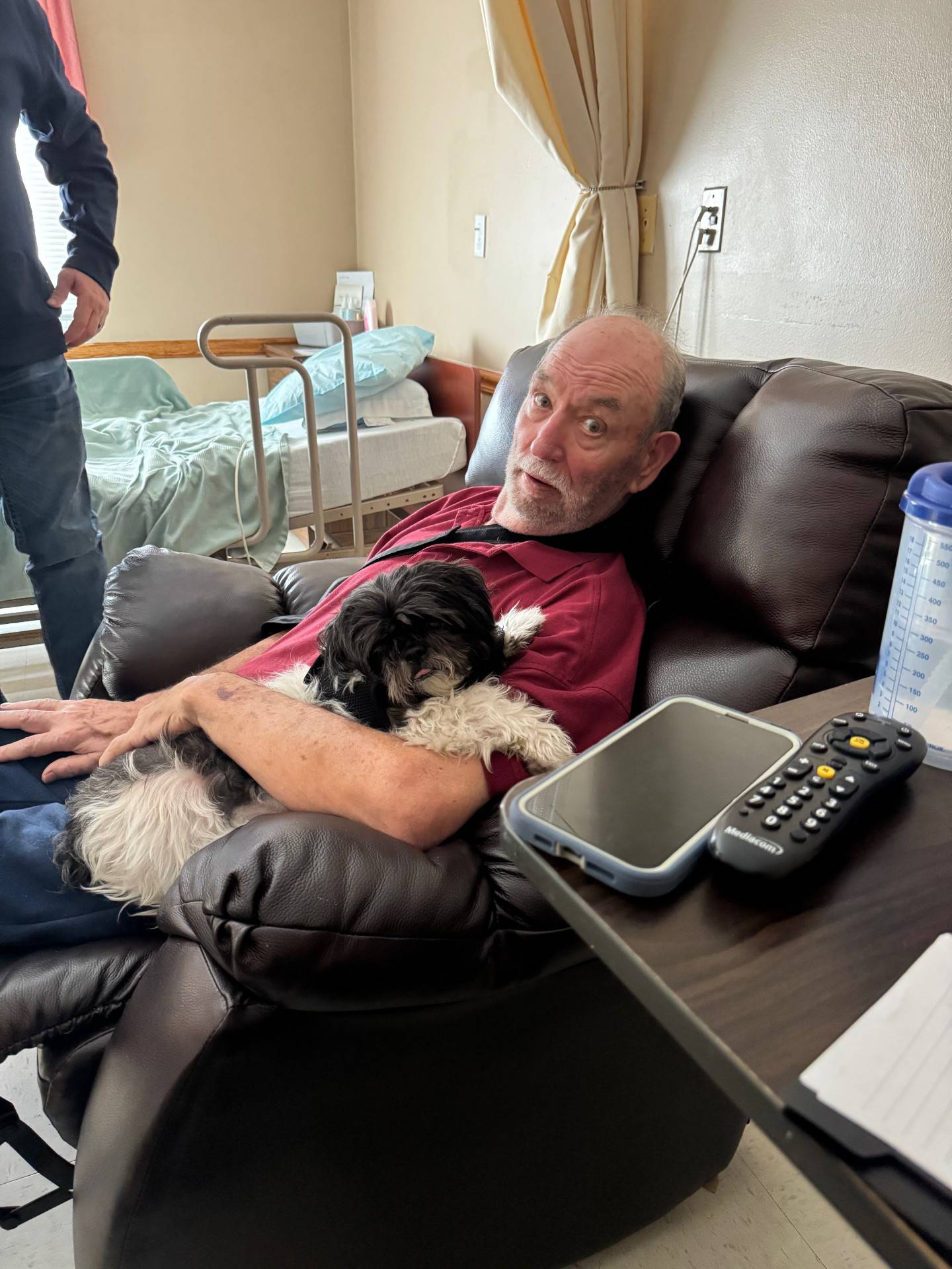 Lovett's Towing and Recovery founder Bill Lovett is seen cuddling with his dog in this undated photo.