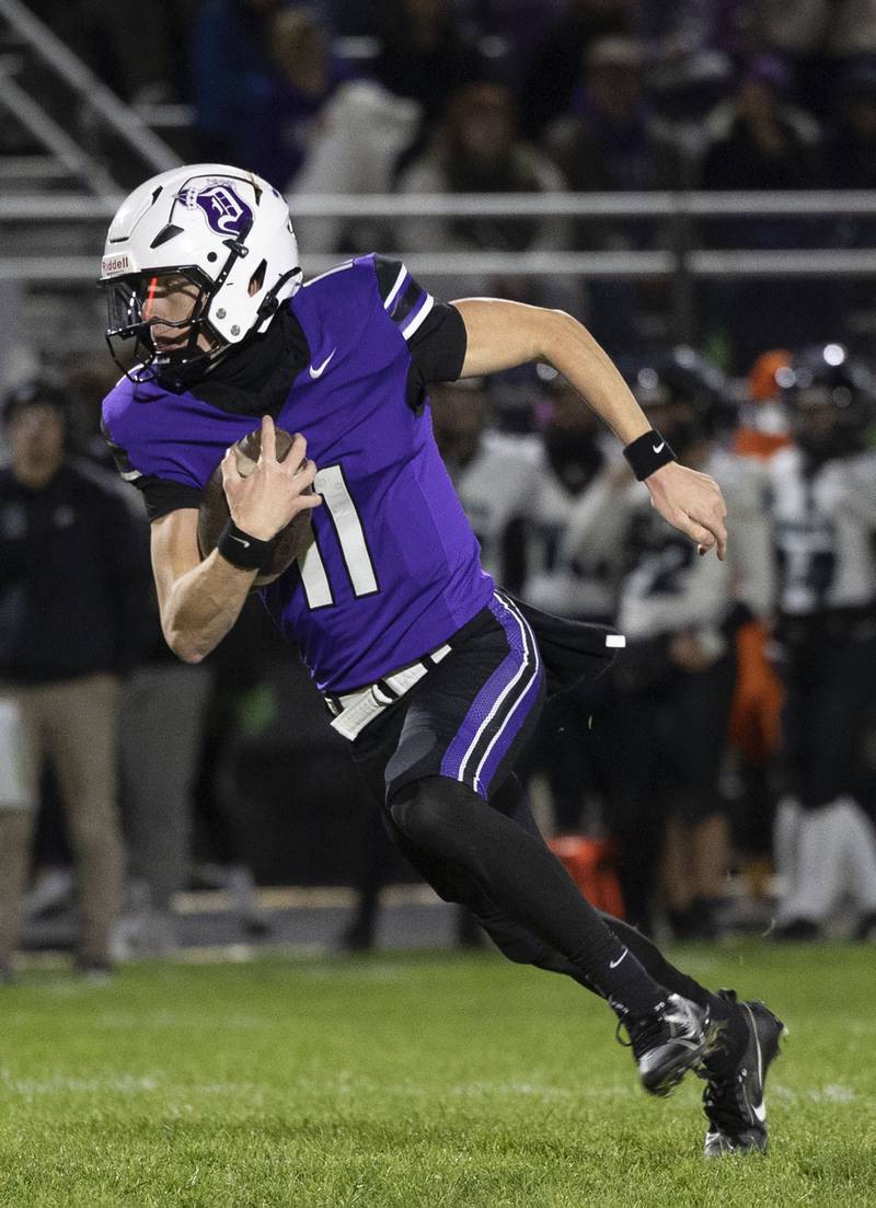 Dixon’s Jagger Kemp looks for running room against Woodstock North Friday, Oct. 31, 2025, in the Class 4A football first round playoffs.