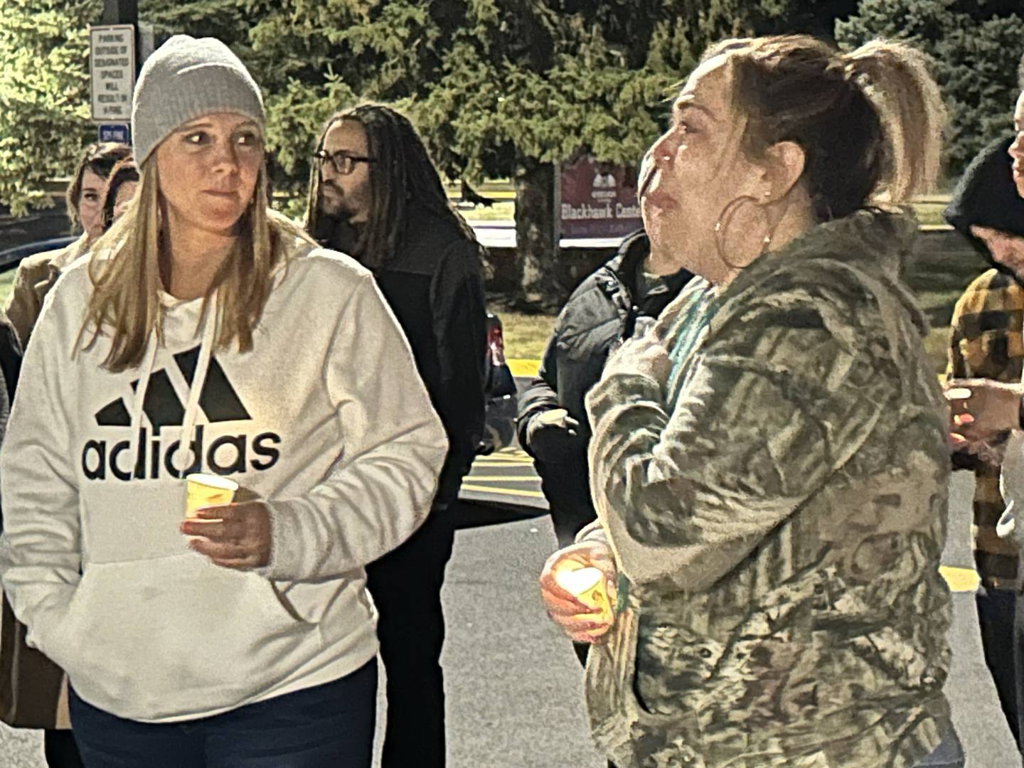 Heidi Zimmernan (left) listens as Jordan Garcia, the mother of Jaedyn Hill, 16, speaks at a candlelight vigil on Sunday, Oct. 27, 2024 in the Blackhawk Center parking lot near the Oregon High School. Police say Hill was killed by her boyfriend in an apartment they shared in Ashton.