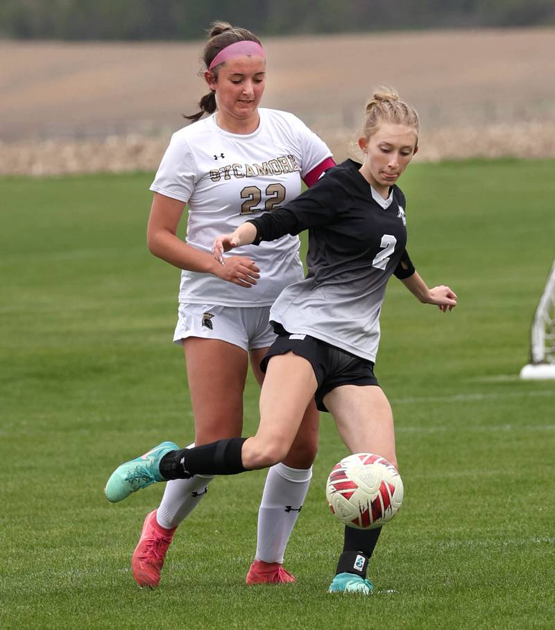 Kaneland's Hannah Boyer tries to hold off Sycamore's Hailey Clawson Wednesday, April 30, 2025, during their game at Kaneland High School in Maple Park.