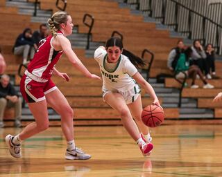 York's Anna Filosa (2) drives to the basket during basketball game between Hinsdale Central at York. Dec 8, 2023.