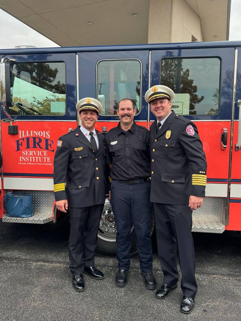 Max Biesack, who recently graduated from the Illinois Fire Service Institute Fire Academy and was hired in February, poses for a picture with Deputy Chief Mike Mills and Chief Brian Bressner.