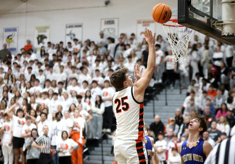 Wheaton Warrenville South's Brady Goken gets the ball in the basket during a game against Wheaton North on Friday, Feb. 7, 2025 in Wheaton.