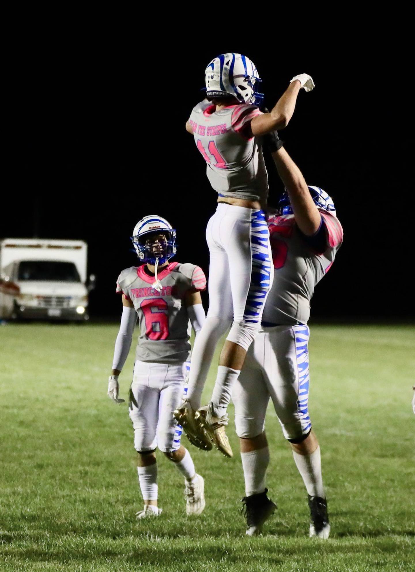 Princeton lineman Payne Miller lifts teammate Noah LaPorte after he scored a touchdown Friday night at Bureau Valley.