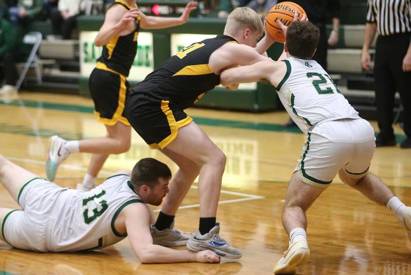 Ashton-Franklin Center's Kyle Goldman pulls a rebound away from St. Bede's Mason Ross and teammate Gus Burr during the Class 1A Regional quarterfinal game on Monday, Feb. 24, 2025 at St. Bede Academy.