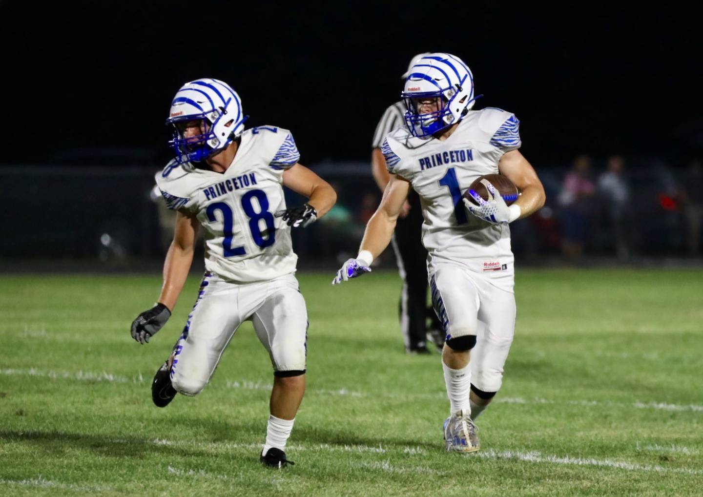 Princeton's Casey Etheridge gets a lead block from fullback Preston Arkels at Monmouth-Roseville Friday night. Etheridge scored four touchdowns to lead Princeton to a 40-0 victory.