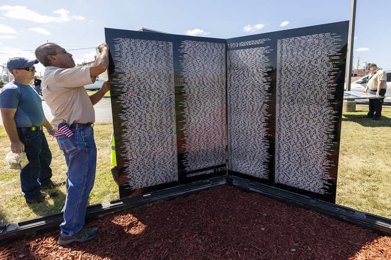 The first two panels of the Vietnam Traveling Memorial Wall are installed Thursday, August 31, 2023 at RB&W Park in Rock Falls.