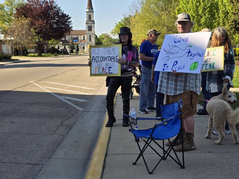 Residents holds signs on Tuesday, May 6, 2025, at Streator City Park promoting peace and accountability for those committing violent acts.