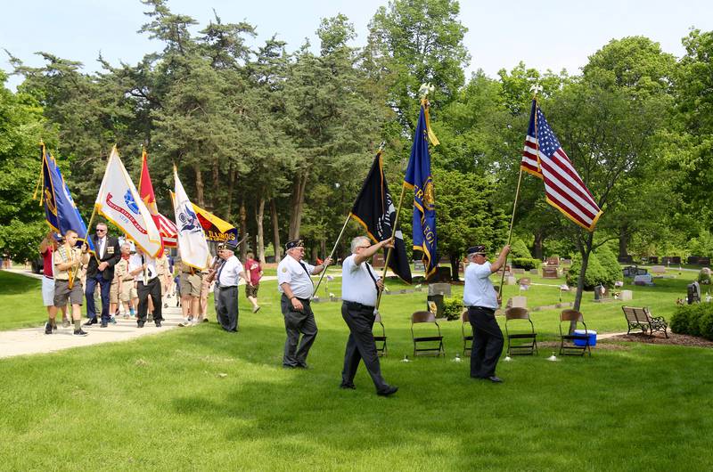 Participants of the Memorial Day Procession enter Blackberry Cemetery in Elburn as part of the Memorial Day Ceremony on Monday, May 30, 2022.