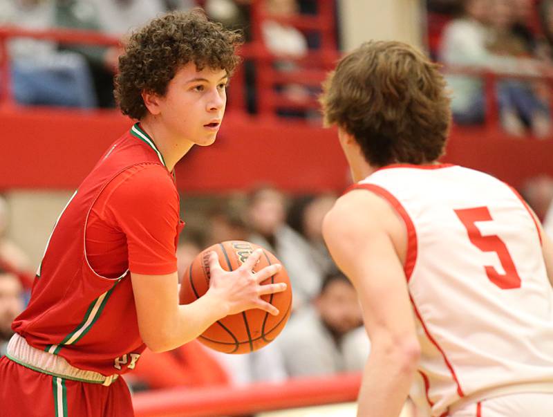 L-P's Michael Hartman looks to pass the ball around Ottawa's Aiden Mucci in Kingman Gymnasium on Friday, Feb. 10, 2023 at Ottawa High School.