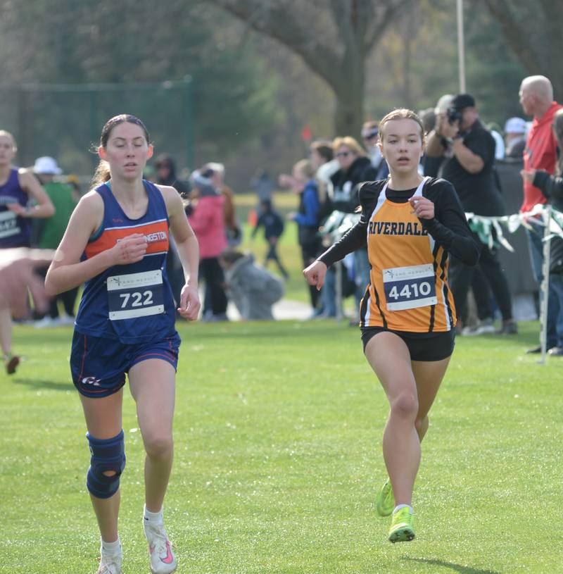 Riverdale's Ava Gaulrapp races Genoa-Kingston's Gracie Zapatka to the finish line at the 1A Rock Island Cross Country Sectional on Saturday, Nov. 2, 2024 at Saukie Golf Course in Rock Island.
