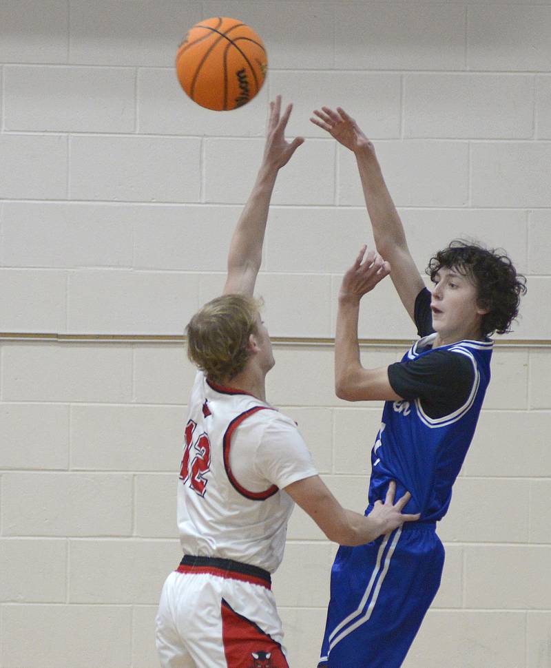 Newark’s Austin Reibel works to get this pass over the block attempt by Hall’s Chance Sterling in the 1st period Tuesday at Serena.